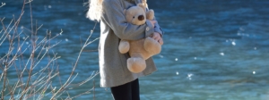 woman holding a large teddy bear